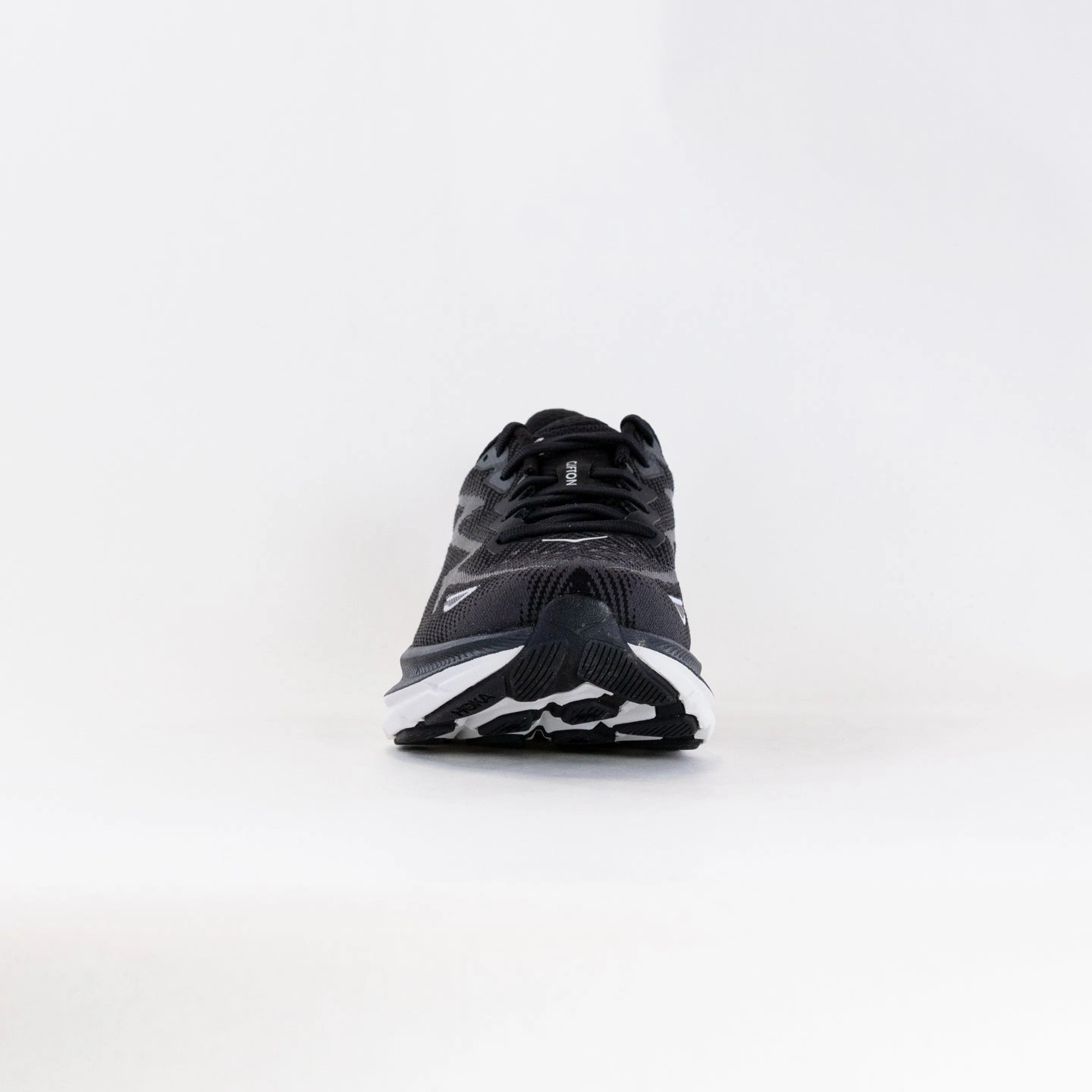 Hoka Clifton 9 Wide (Women's) - Black/White running with a hydration pack