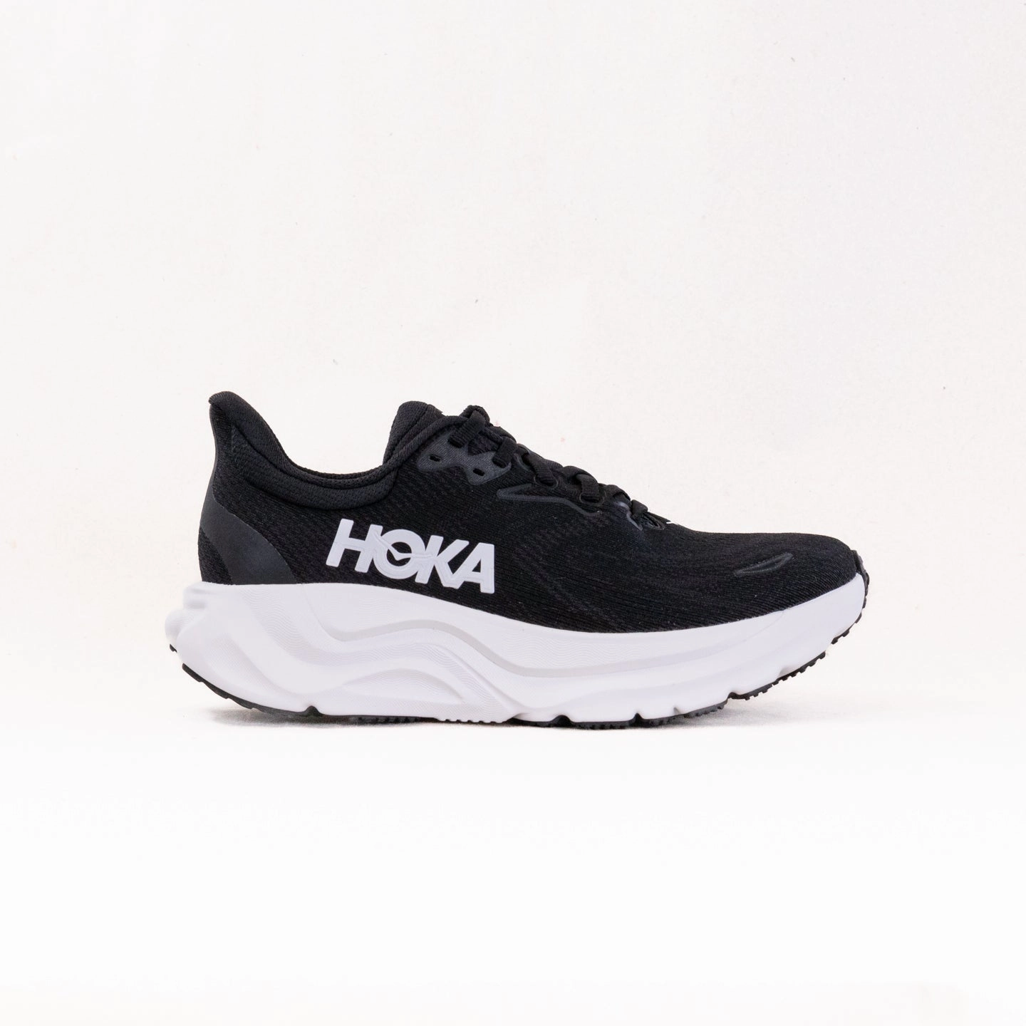 Hoka Arahi 8 (Women's) - Black/White running sock running in a school yard shoes