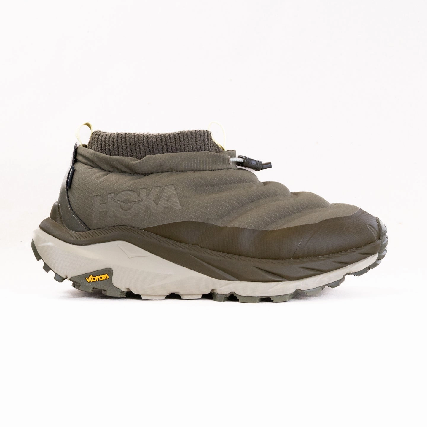 Hoka Kaha 2 Frost Moc GORE-TEX? (Men's) - Antiq ive/Spruce Green running on a gravel road